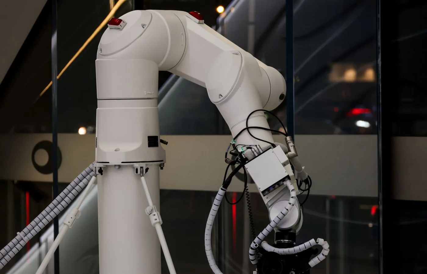 White multi-axis robotic arm in a modern automation setting